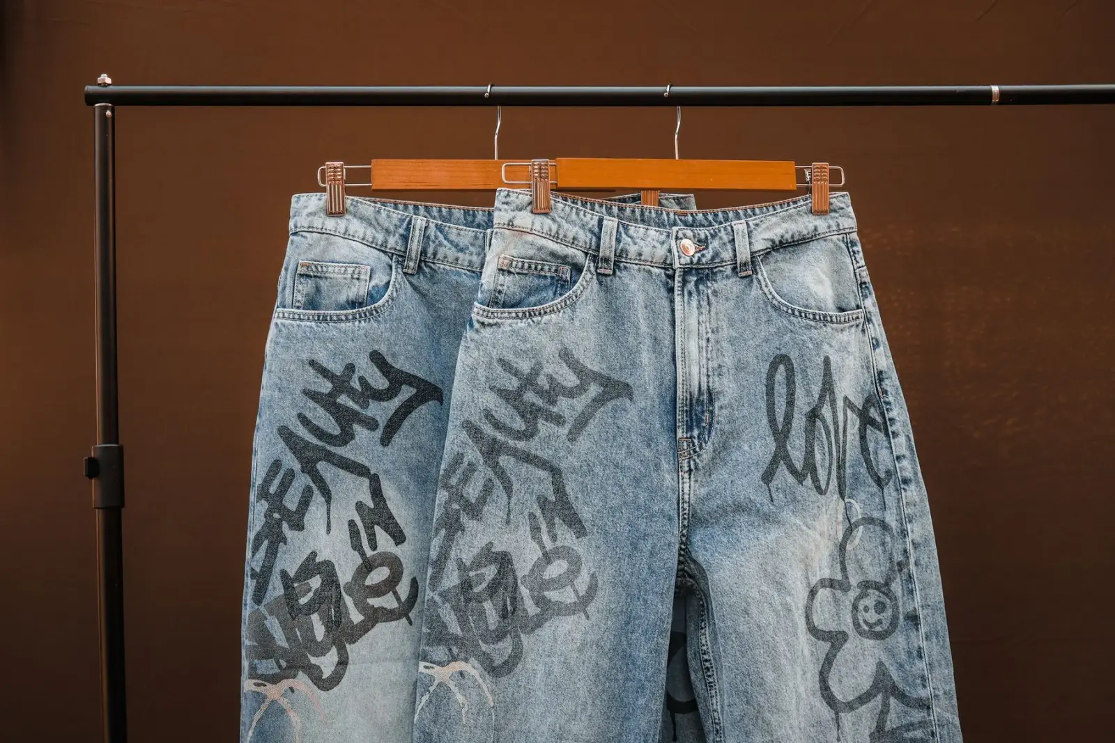 Chiếc quần denim in hoạ tiết vẽ tay, chụp cận phần ống